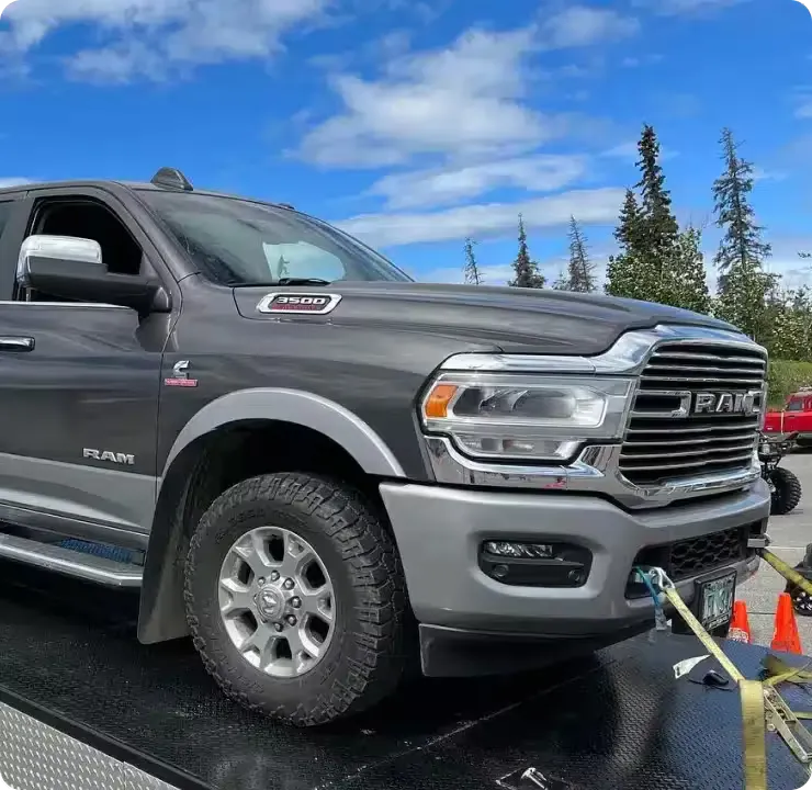 A gray Ram 3500 on a towing vehicle
