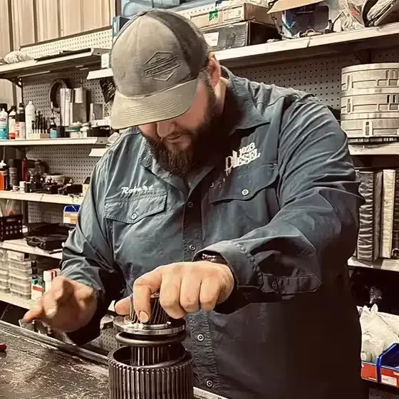 A technician rebuilding a transmission at 1023 Diesel & Fleet